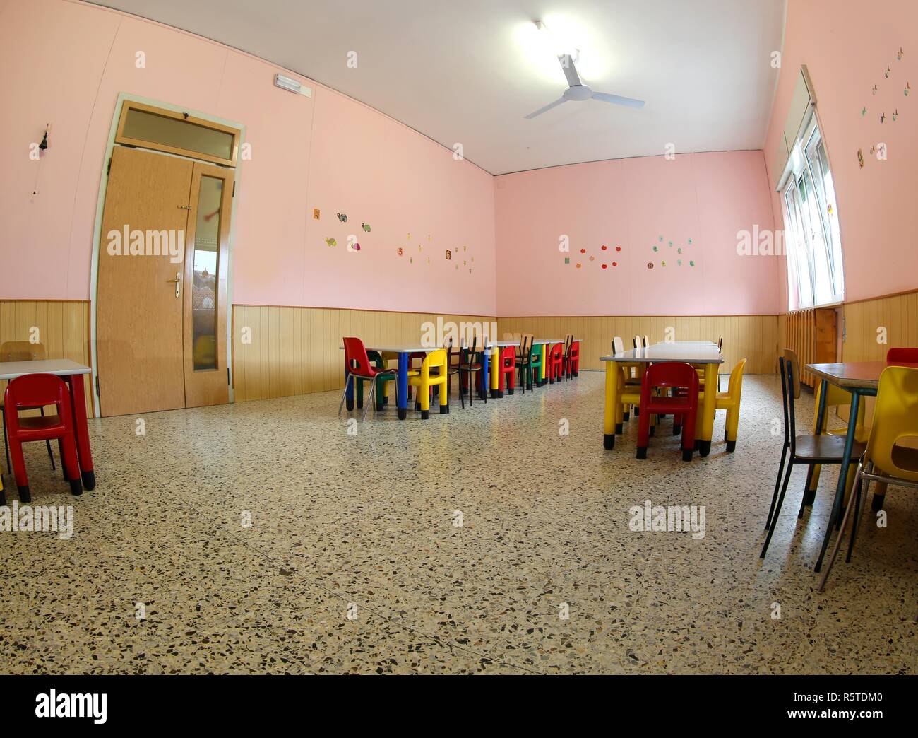 inside the refectory of a school for children with small tables and small chairs suitable for kids Stock Photo