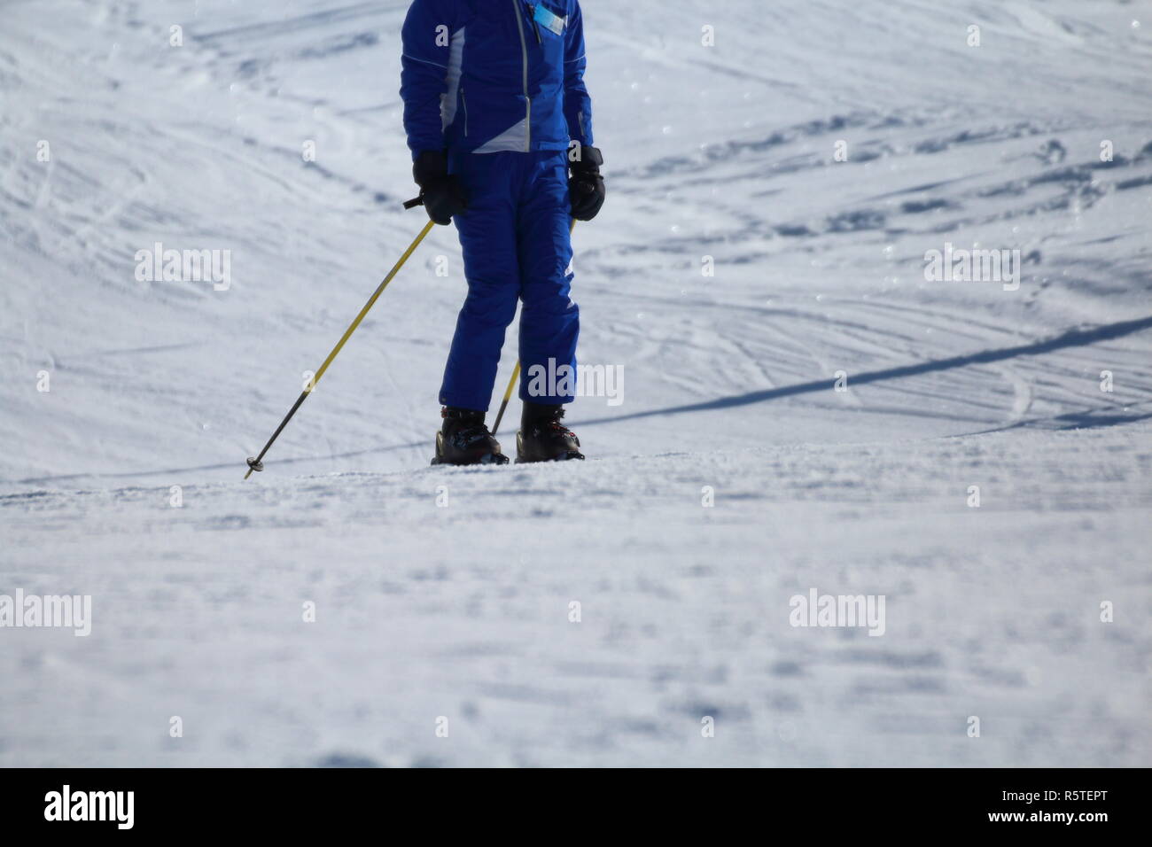 a ski athlete arrives at the end of the descent Stock Photo