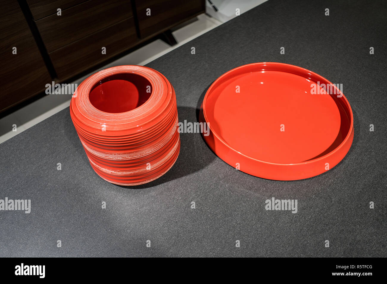 Red tableware on loft stylish table background Stock Photo