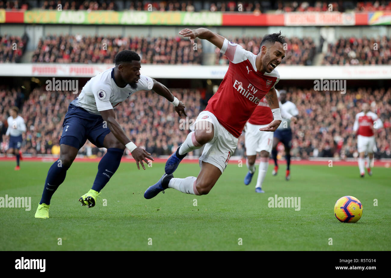Arsenal's Pierre-Emerick Aubameyang (right) and Tottenham Hotspur's Serge Aurier during the Premier League match at Emirates Stadium, London. Stock Photo