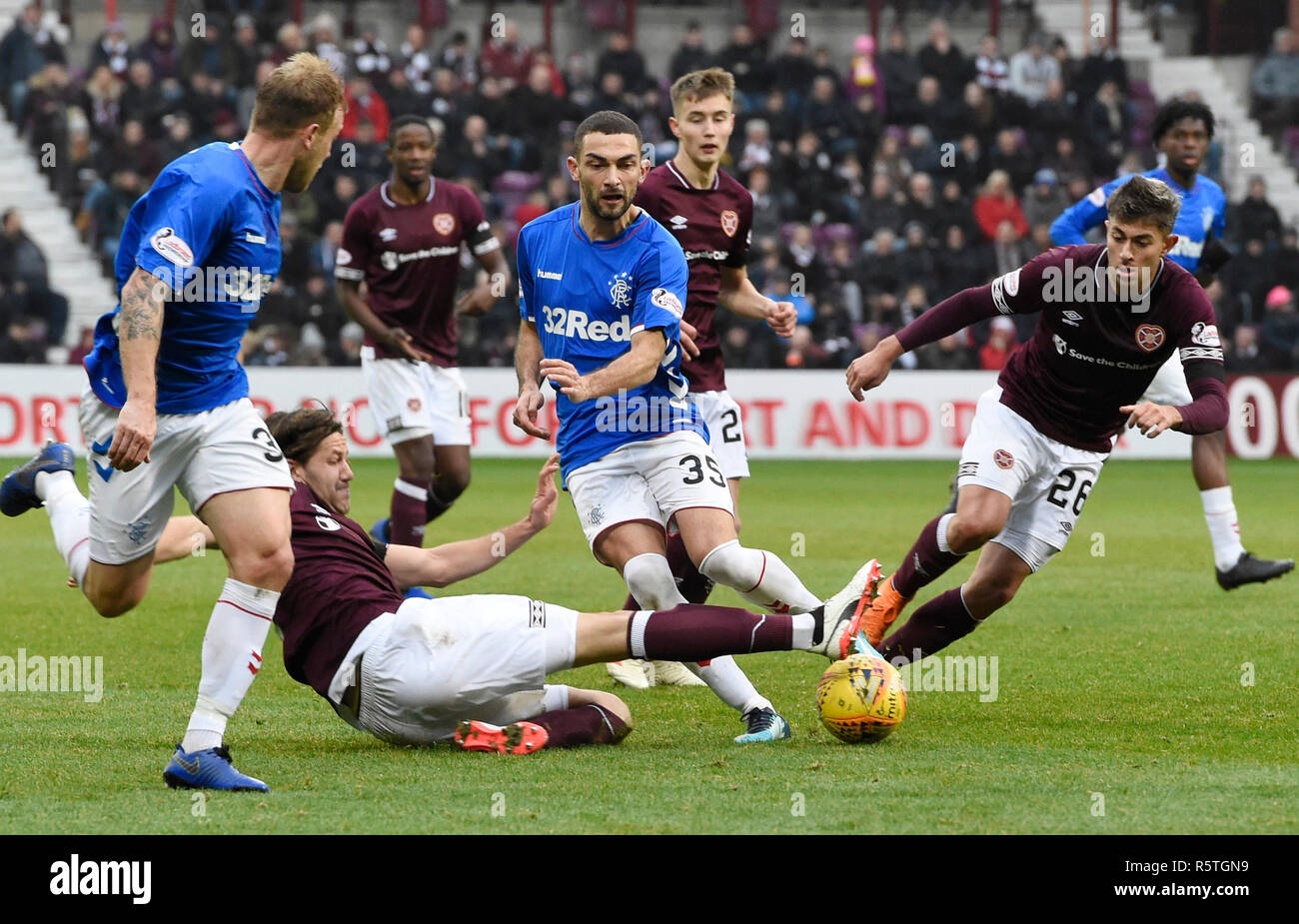 Rangers' Eros Grezda is tackled by Hearts Peter Haring as he tries to slip the ball through to Rangers Scott Arfield during the Ladbrokes Scottish Premiership match at Tynecastle Stadium, Edinburgh. Stock Photo