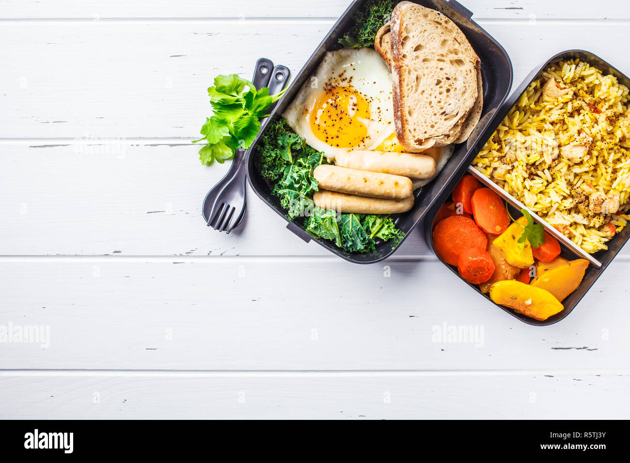 Meal prep containers with rice with chicken, baked vegetables, eggs