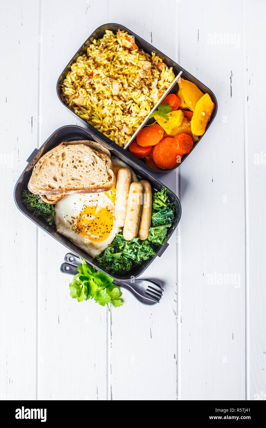 Meal prep containers with rice with chicken, baked vegetables, eggs