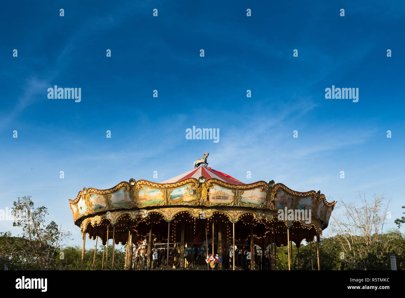 A carrousel  and clear sky (fair attraction) at  X'matkuil county fair in Yucatan México Stock Photo