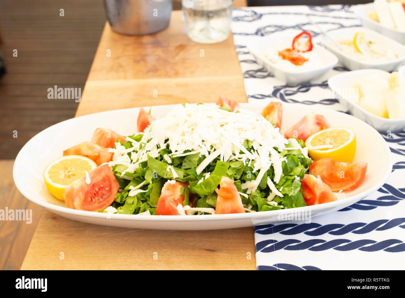 Mediterranean style salad for fish meal on wood Stock Photo