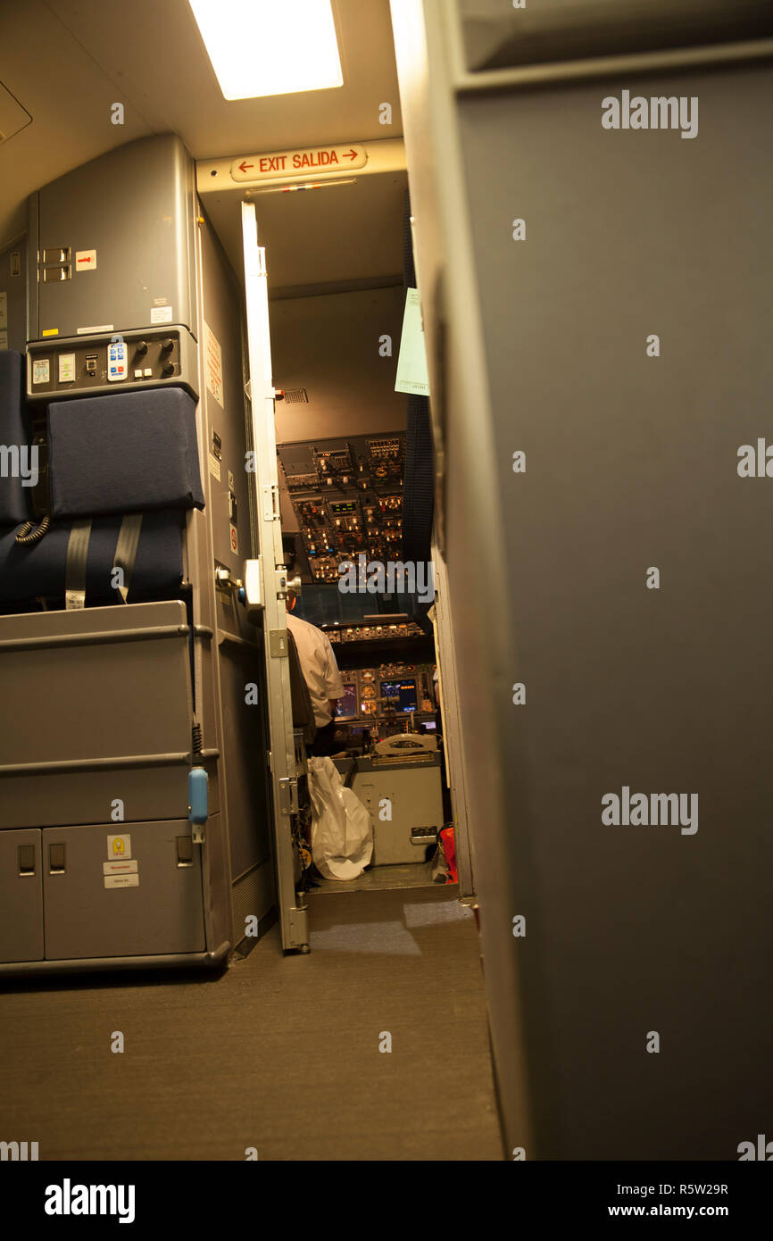 Inside passenger airplane with cockpit door open before takeoff Stock