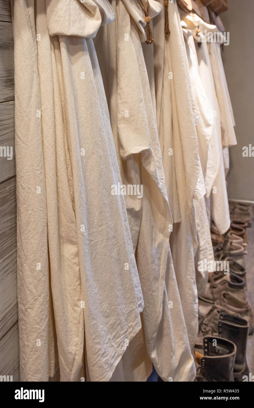Monks robes hanging on a wall. Stock Photo