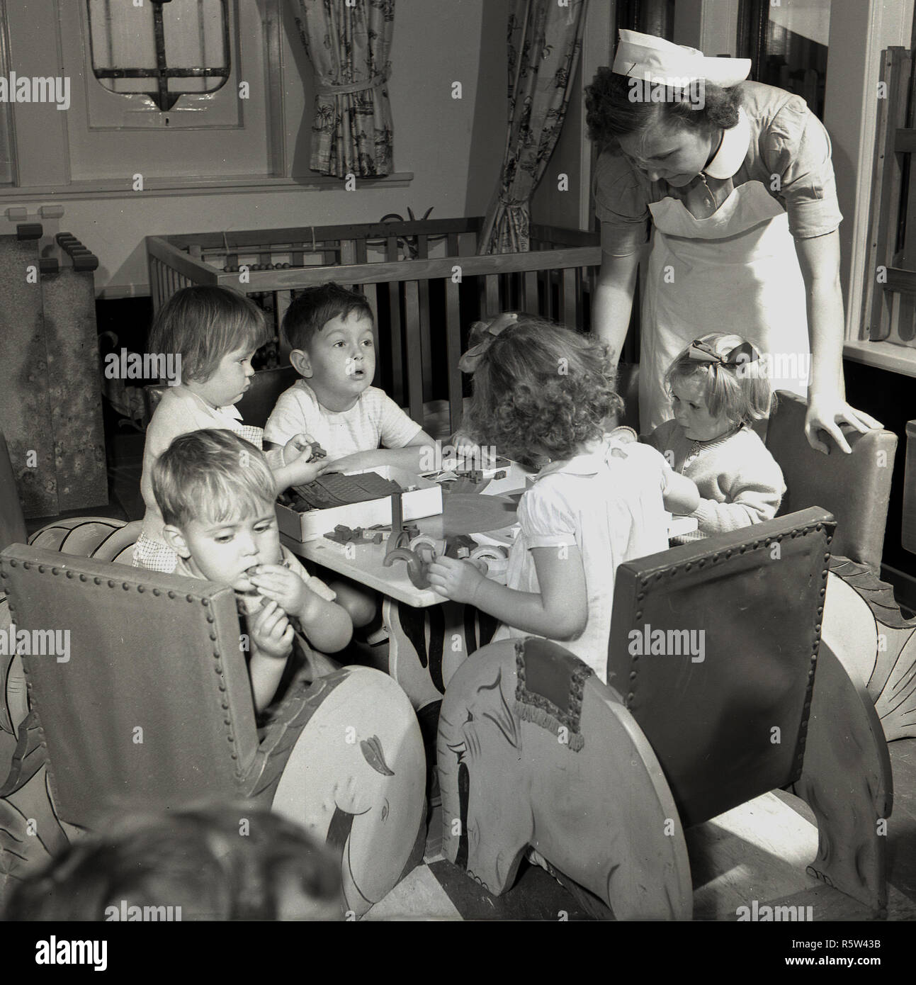 1950s Historical A Uniformed Female Nurse Looking After Young Children Passengers Onboard A Union Castle Steamship A Cruise Ship That Took Travellers Cargo And Mail Across The Oceans Stock Photo Alamy