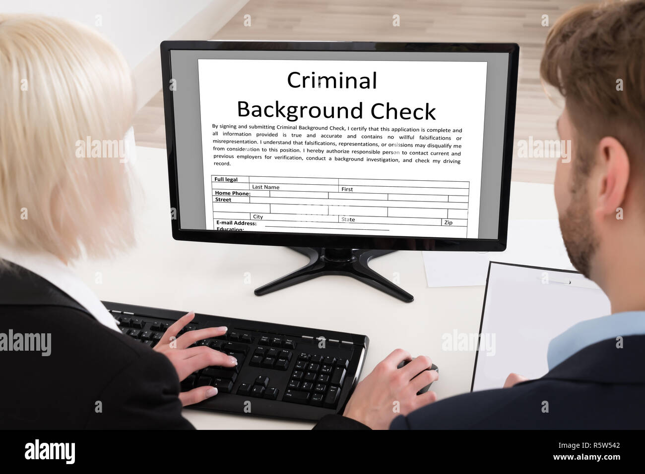 Businesspeople Analyzing Graph On Computer Stock Photo