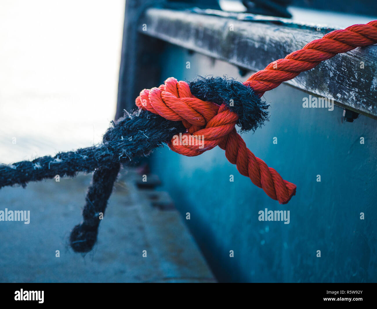 Two different colored ropes tied together at a mooring Stock Photo Alamy