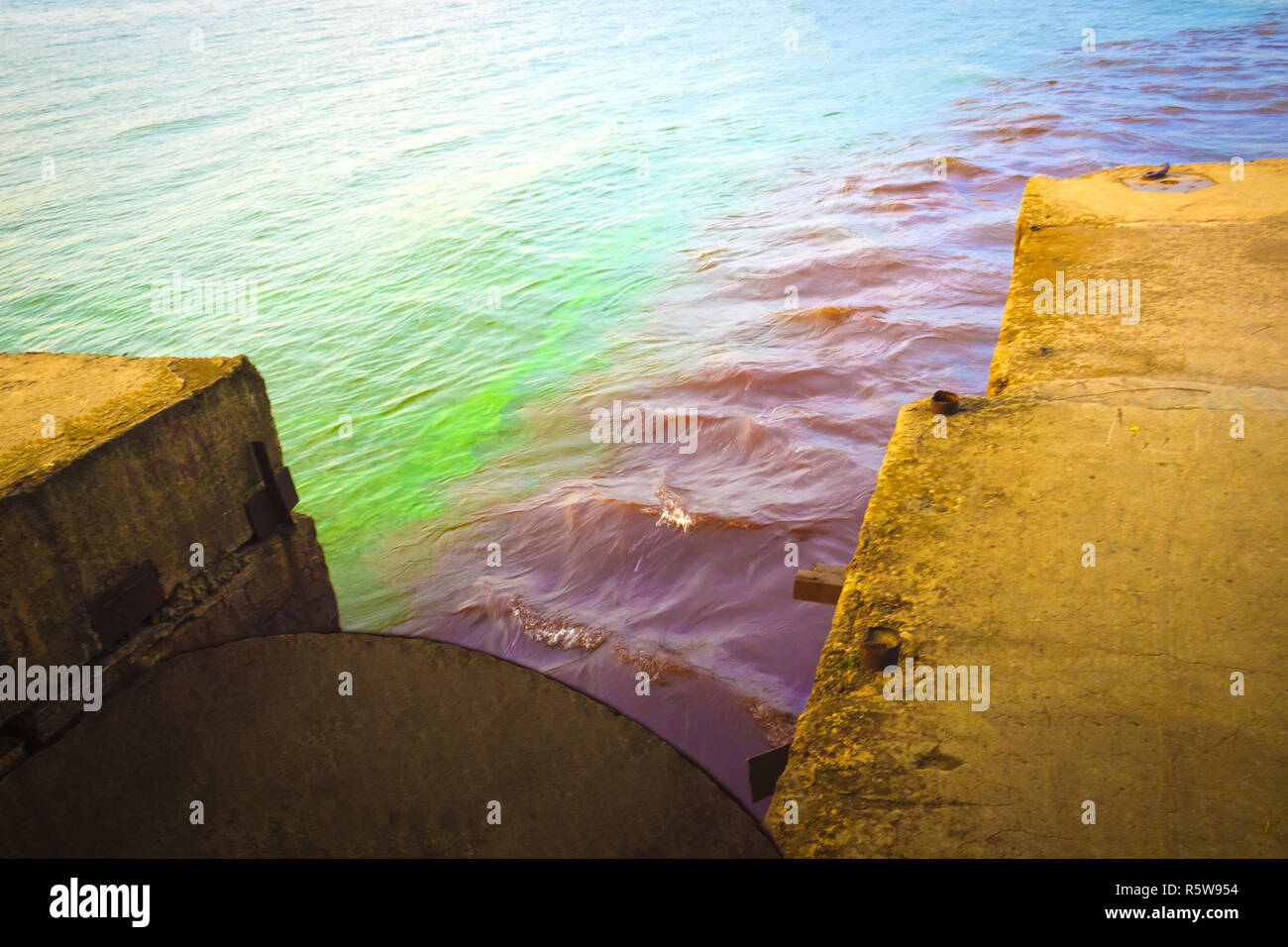 riverscape of large drainage steel pipe background Stock Photo - Alamy