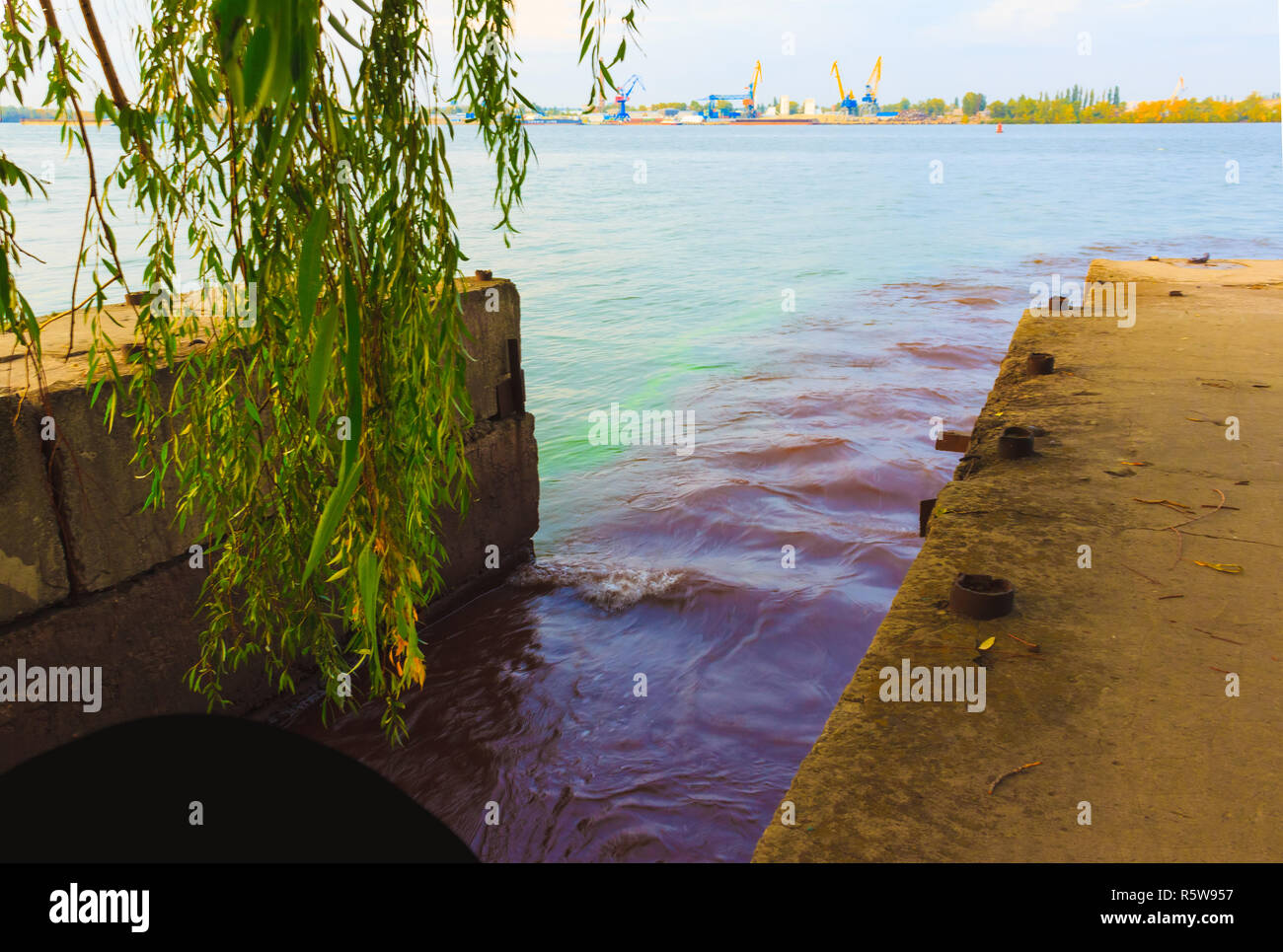 riverscape of large drainage steel pipe background Stock Photo - Alamy