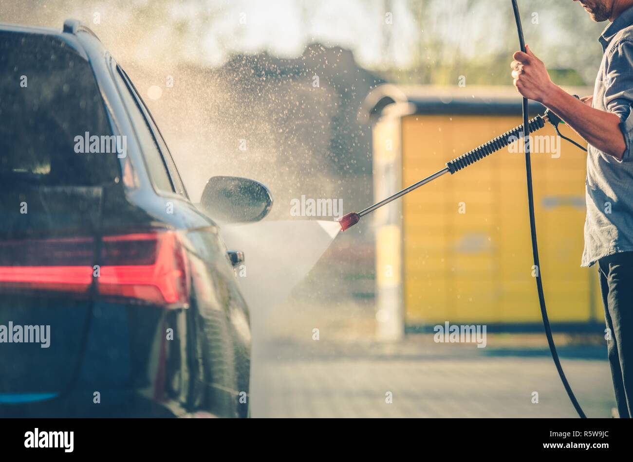 Detailed Car Washing by Caucasian Men. Pressure Washer in Use. Vehicle Maintenance. Automotive Industry. Stock Photo