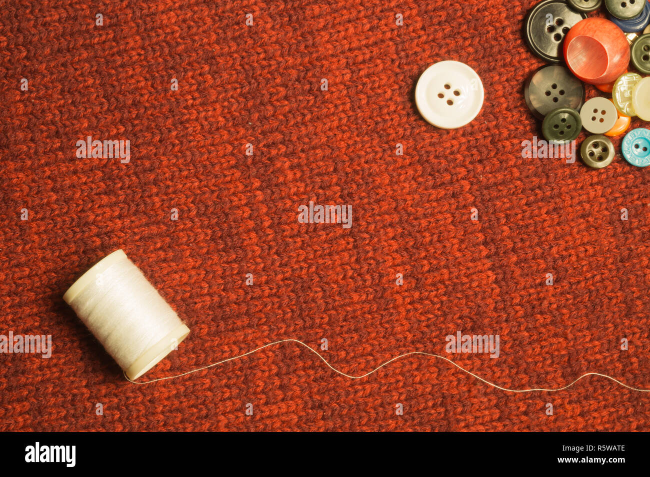 Various sewing buttons on textile background Stock Photo