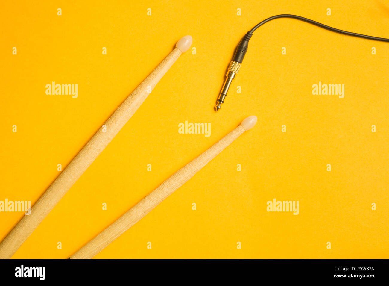 Used drumsticks isolated on yellow background Stock Photo - Alamy