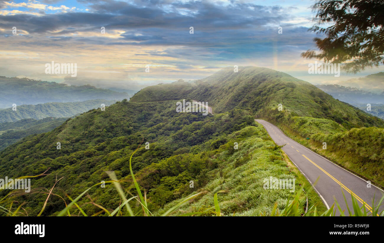 road under a sunrise time with nice sky with soft clouds Stock Photo