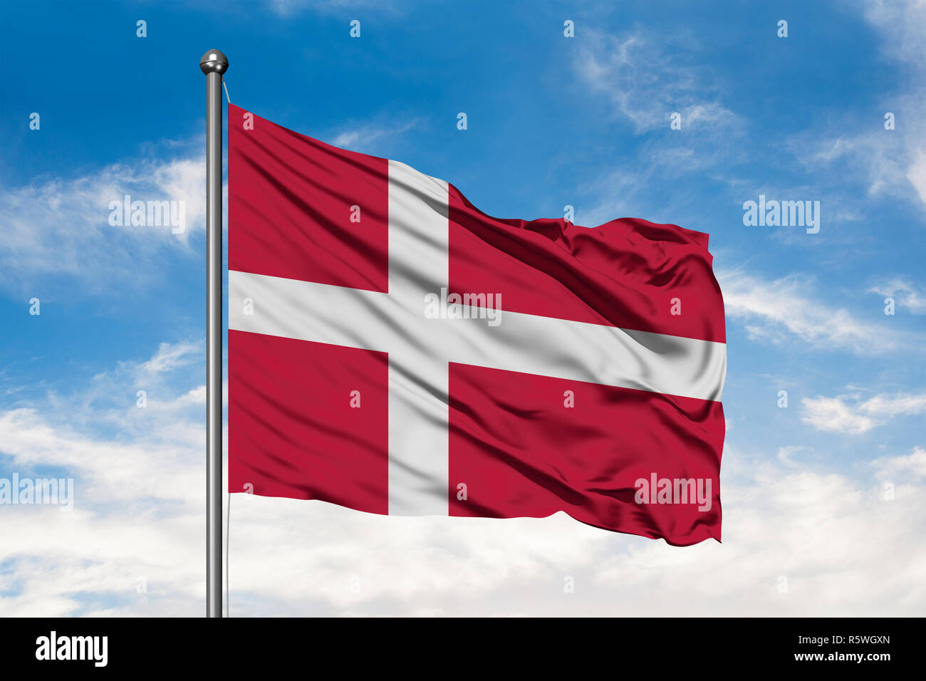 Flag of Denmark waving in the wind against white cloudy blue sky ...
