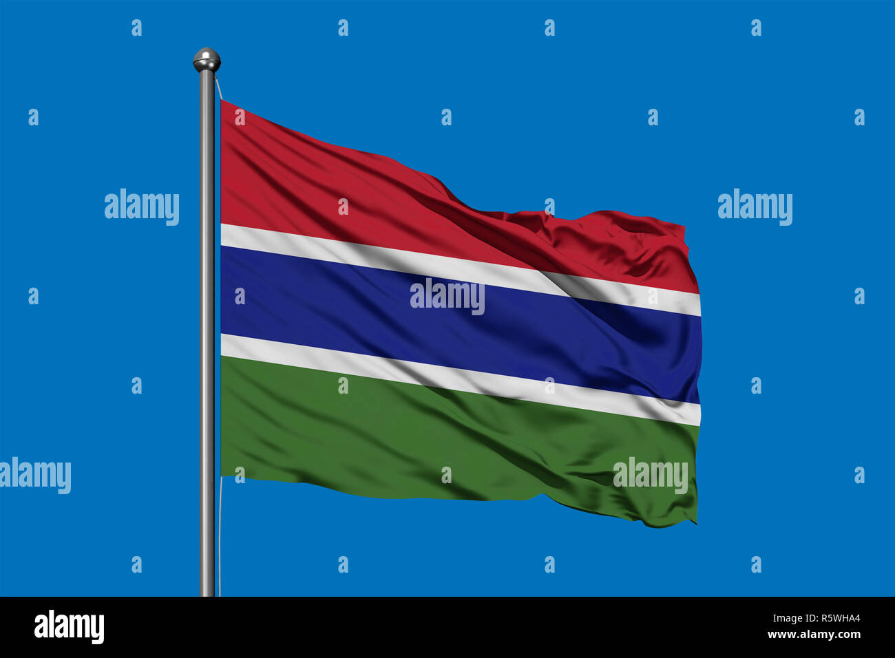 Flag of Gambia waving in the wind against deep blue sky. Gambian flag ...