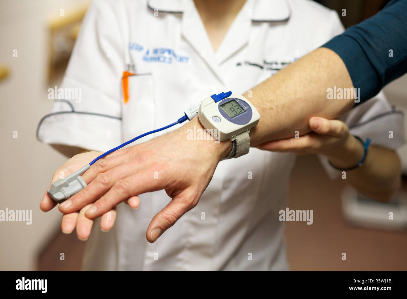 A nurse uses a pulse oximeter to monitor a patients oxygen saturation