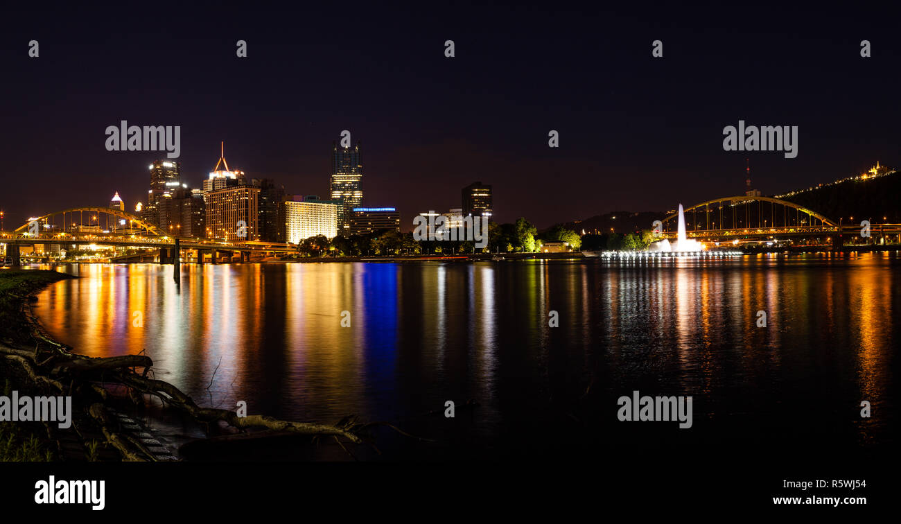 Panoramic nighttime view of Pittsburgh skyline from the confluence of Allegheny and Monongahela rivers Stock Photo