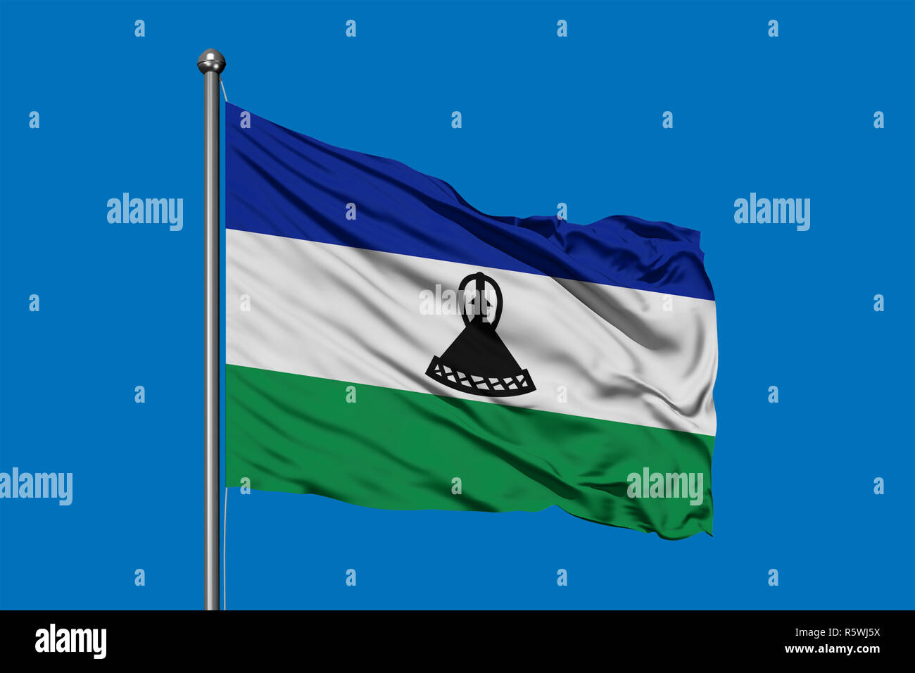Flag of Lesotho waving in the wind against deep blue sky. Kingdom of ...