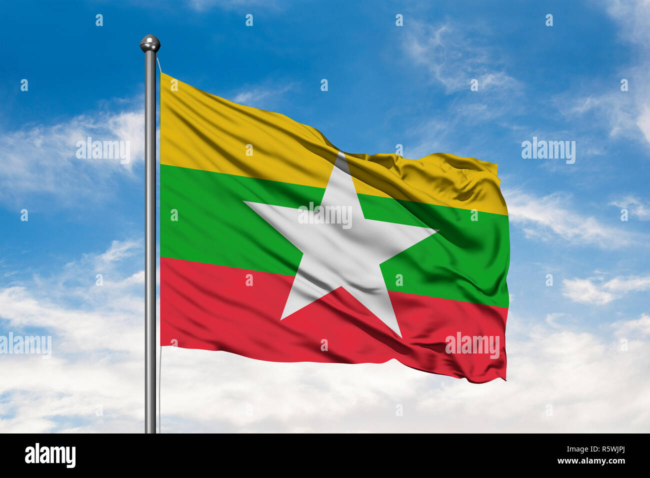 Flag of Myanmar waving in the wind against white cloudy blue sky. Burma ...