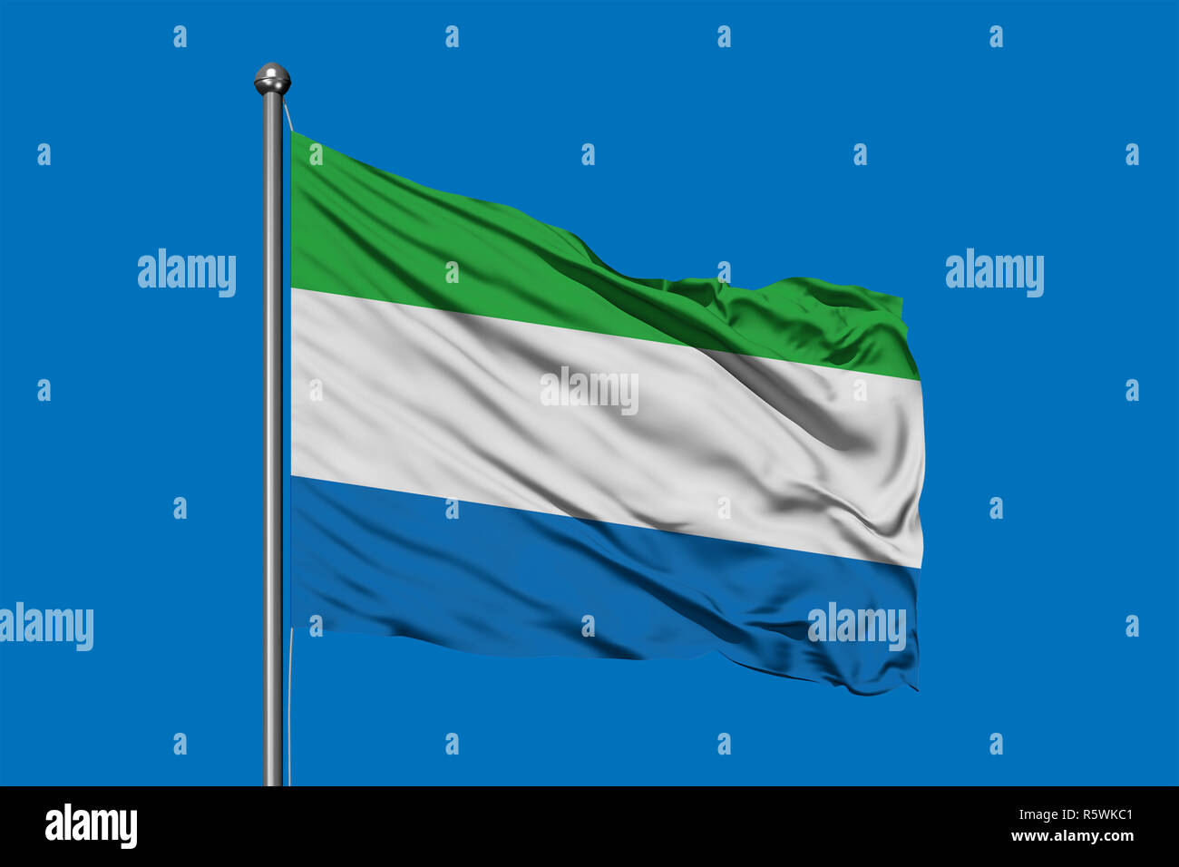 Flag of Sierra Leone waving in the wind against deep blue sky. Sierra ...