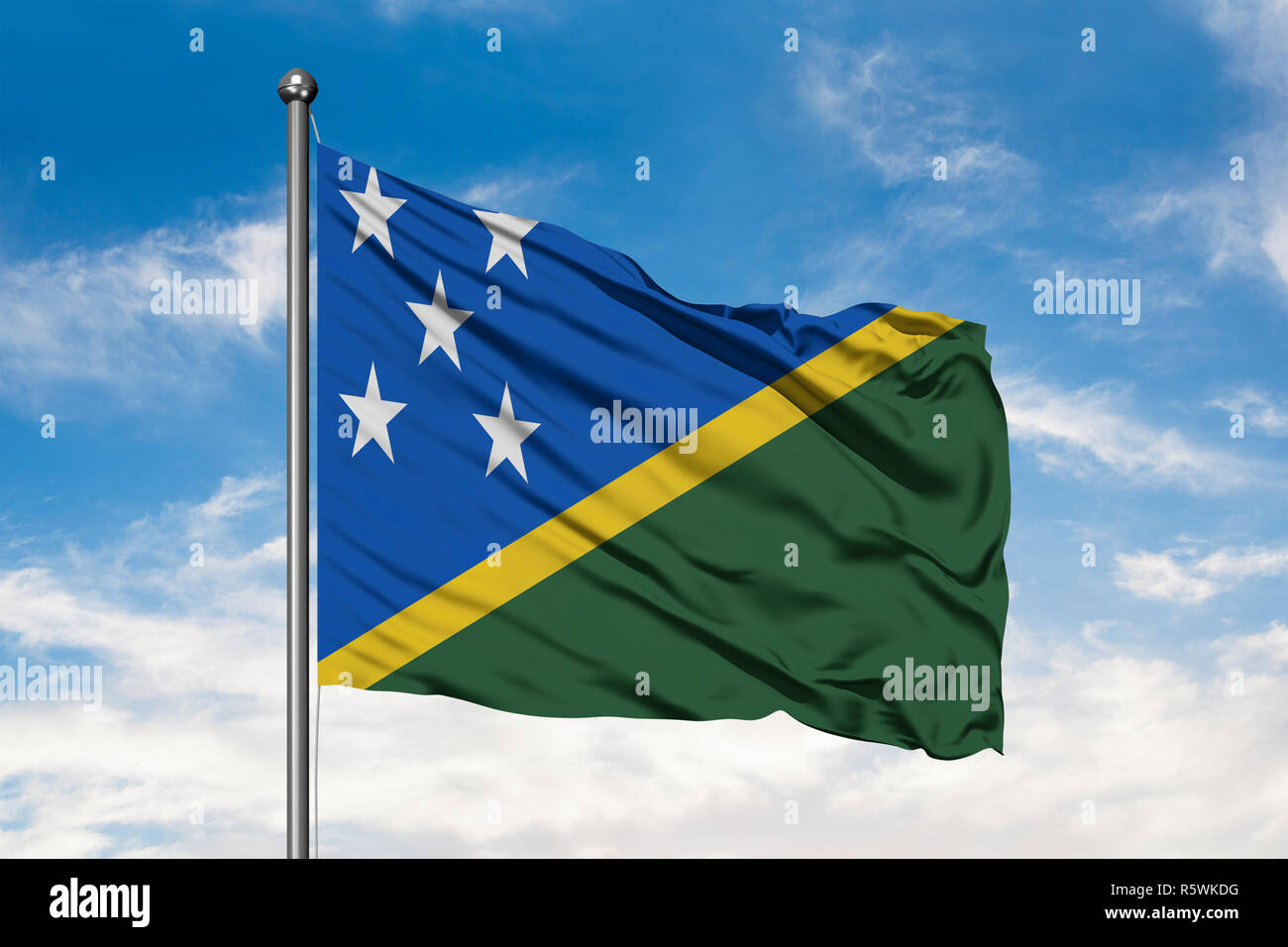 Flag of Solomon Islands waving in the wind against white cloudy blue ...