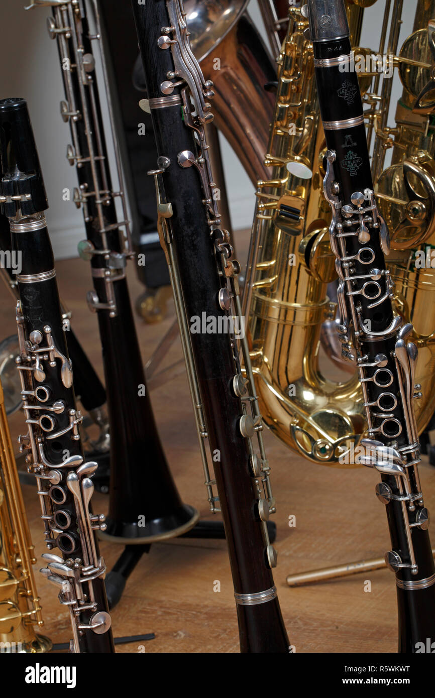 Collection of woodwind instruments, clarinets and saxophones, Wooden and metal instruments Stock Photo