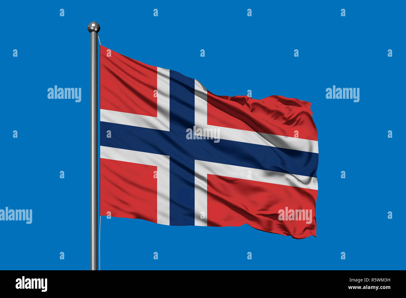 Flag of Svalbard and Jan Mayen waving in the wind against deep blue sky