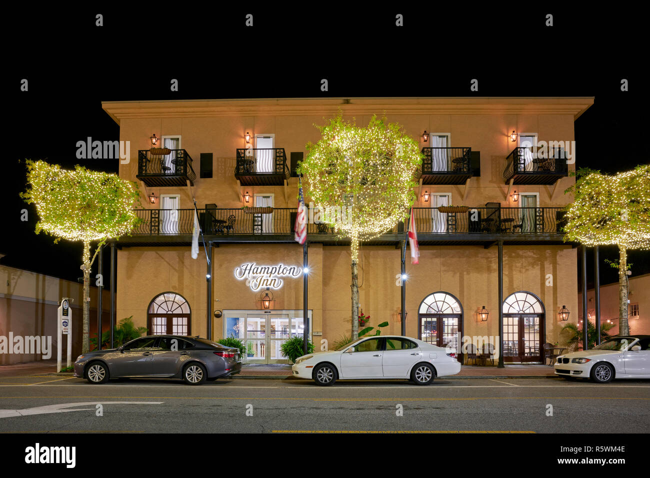 Hampton Inn hotel front exterior entrance at night with Christmas lights in the trees in the small town of Fairhope Alabama, USA. Stock Photo