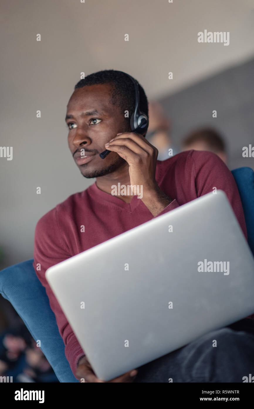 Customer Service agent in an startup office with laptop Stock Photo - Alamy