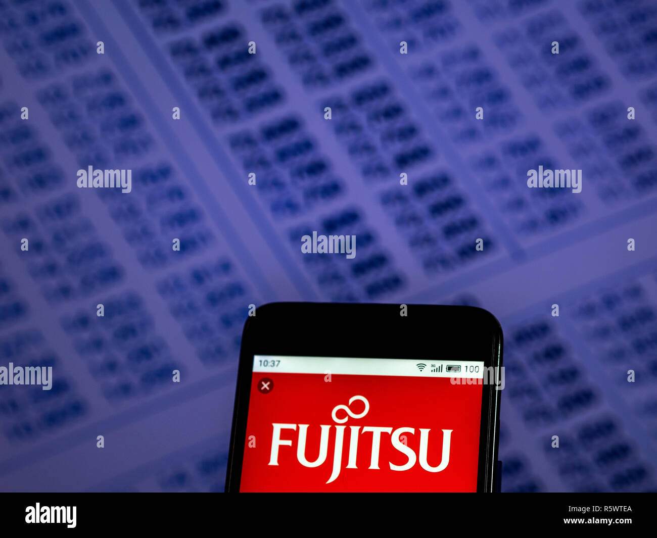 Fujitsu Personal computer equipment company logo seen displayed on smart phone. Stock Photo