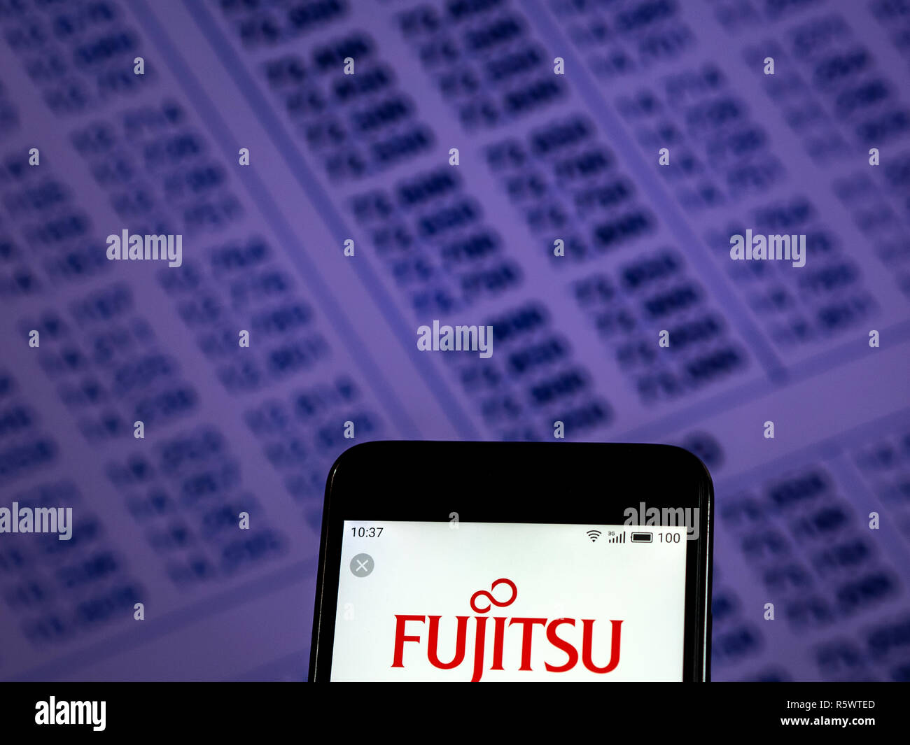 Fujitsu Personal computer equipment company logo seen displayed on smart phone. Stock Photo