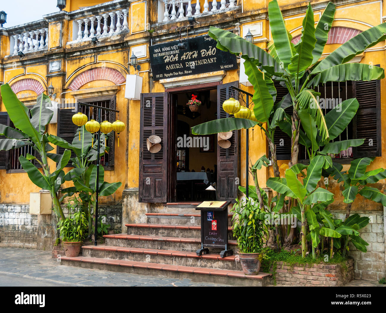 Vietnamese Sakura restaurant (Hoa Anh Dao) on the Hoai River, 119 - 121 Nguyen Thai Hoc Street, Hoi An Old Town, Quang Nam Province,Vietnam Stock Photo