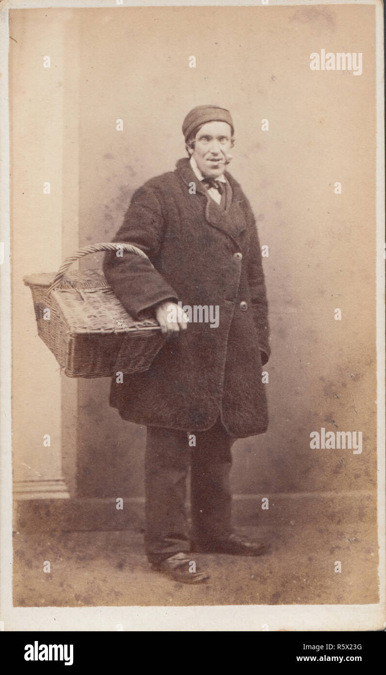 Elgin, Scotland CDV (Carte De Visite) of a Victorian Male Street Seller / Hawker With His Basket. Smoking a Pipe Stock Photo