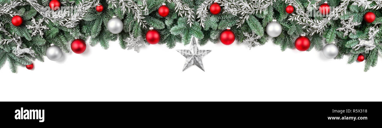 large bow of fresh fir branches,decorated in red and silver,on a white background Stock Photo