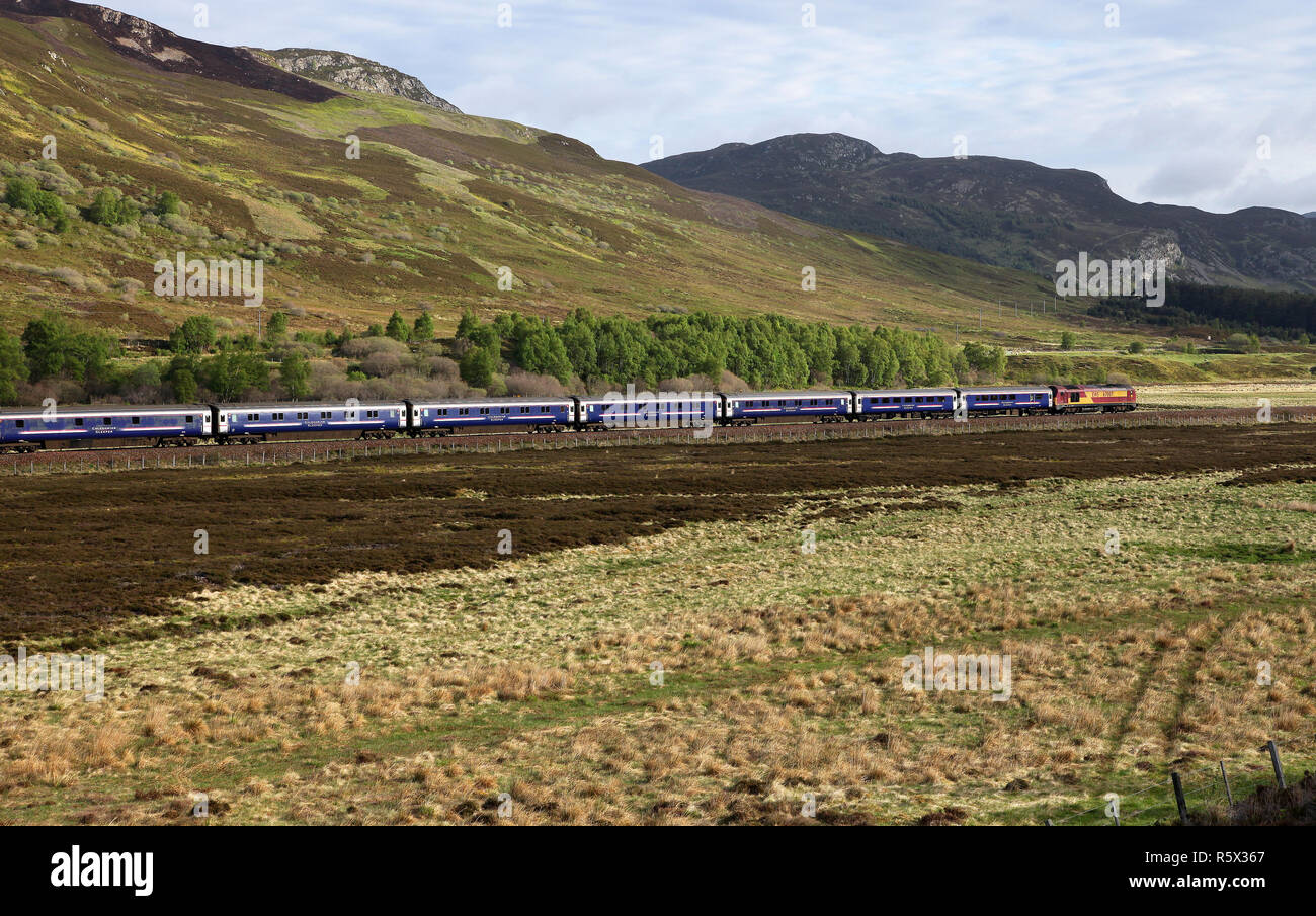 67007 heads past Crubenmore near Dalwhinnie with the Caledonian sleeper service to Inverness. Stock Photo