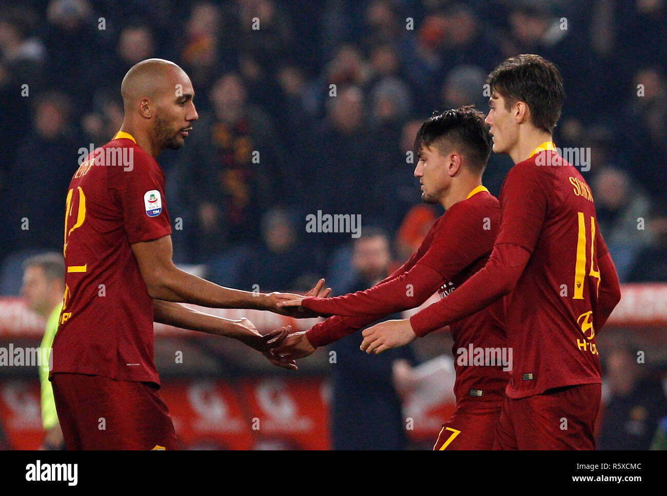 Rome, Italy. 2nd Dec, 2018. Roma's Cengiz Under, center, celebrates with his teammates Steven Nzonzi, left, and Patrik Schick, after scoring during the Serie A soccer match between Roma and Inter at the Olympic Stadium. Credit: UPDATE IMAGES/ Alamy Live News Stock Photo