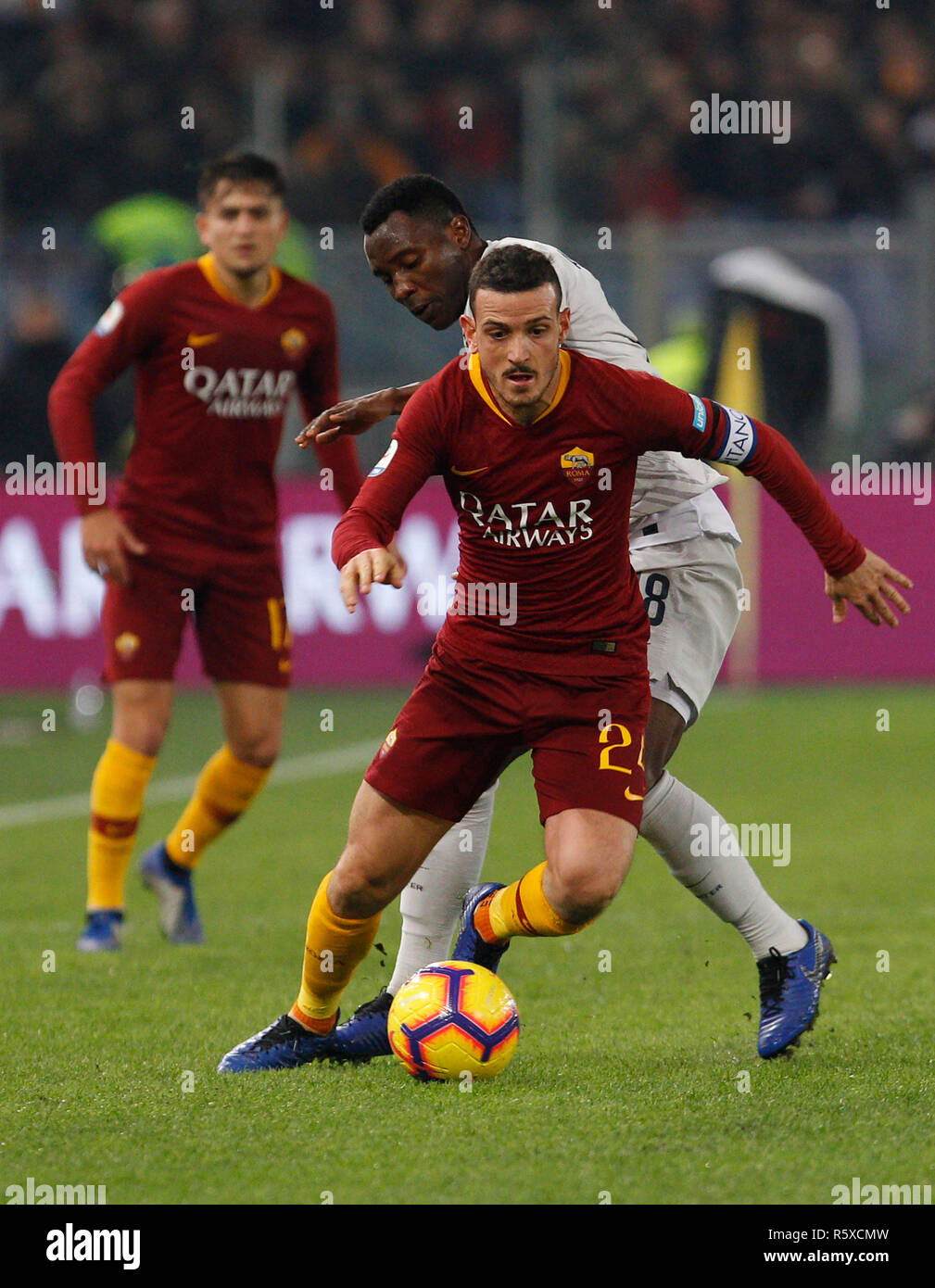 Rome, Italy. 2nd Dec, 2018. Roma's Alessandro Florenzi, foreground, is challenged by Inter's Kwadwo Asamoah during the Serie A soccer match between Roma and Inter at the Olympic Stadium. Credit: UPDATE IMAGES/ Alamy Live News Stock Photo