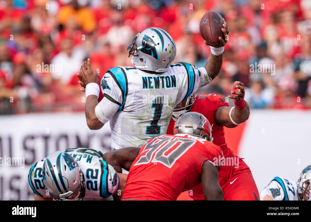 Tampa, Florida, USA. 02nd Dec, 2018. Carolina Panthers quarterback Cam Newton (1) gets rushed and throws an interception to Tampa Bay Buccaneers defensive back Andrew Adams (26) in the 4th quarter during the game between the Carolina Panthers and the Tampa Bay Buccaneers at Raymond James Stadium in Tampa, Florida. Del Mecum/CSM/Alamy Live News Stock Photo