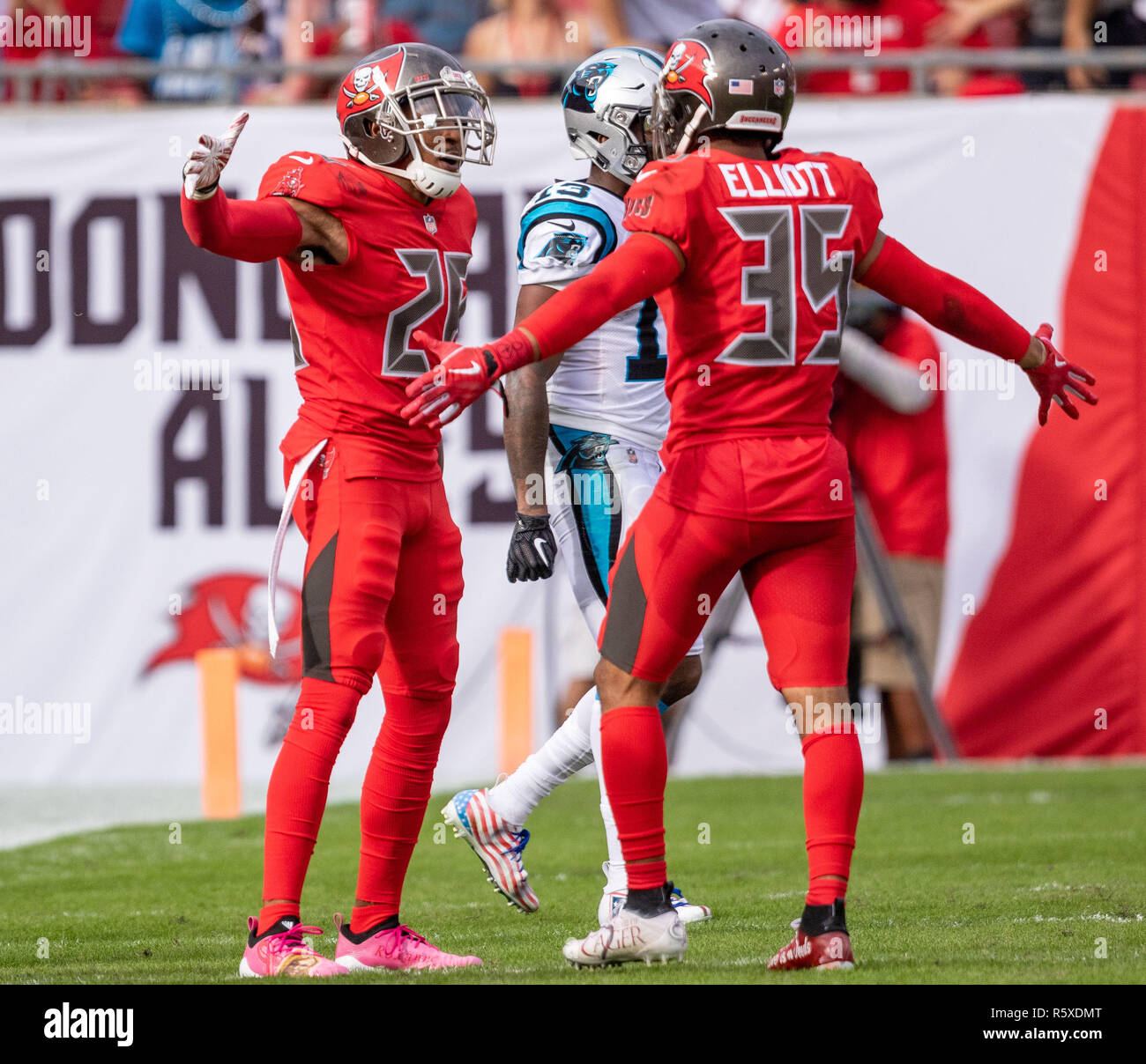 Tampa, Florida, USA. 02nd Dec, 2018. Tampa Bay Buccaneers defensive back Andrew Adams (26) makes his 3rd interception of the game and celebrates with Tampa Bay Buccaneers cornerback Javien Elliott (35) in the 4th quarter during the game between the Carolina Panthers and the Tampa Bay Buccaneers at Raymond James Stadium in Tampa, Florida. Del Mecum/CSM/Alamy Live News Stock Photo