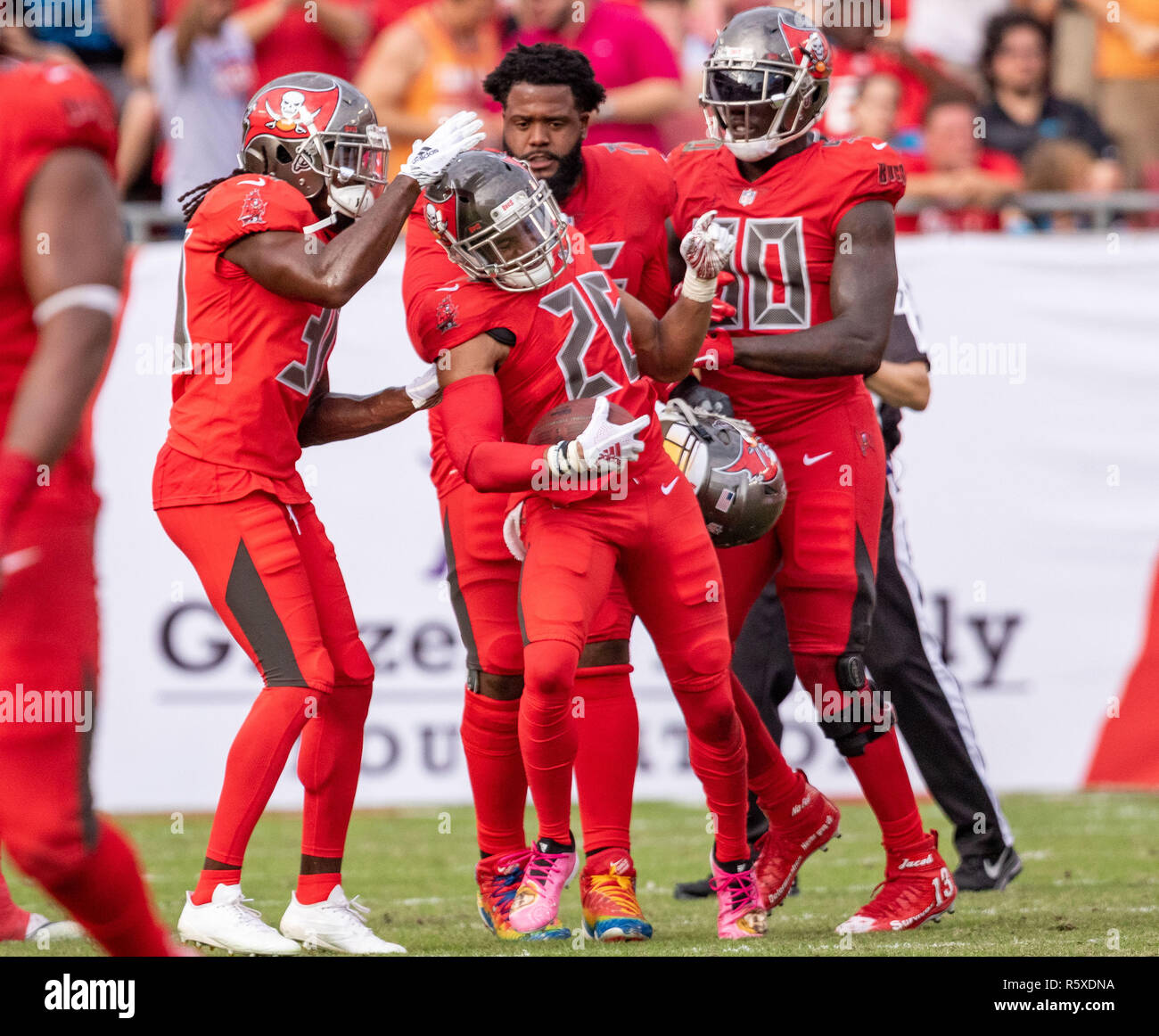 Tampa, Florida, USA. 02nd Dec, 2018. Tampa Bay Buccaneers defensive back Andrew Adams (26) celebrates with teammates after making his 3rd interception of the game during the game between the Carolina Panthers and the Tampa Bay Buccaneers at Raymond James Stadium in Tampa, Florida. Del Mecum/CSM/Alamy Live News Stock Photo