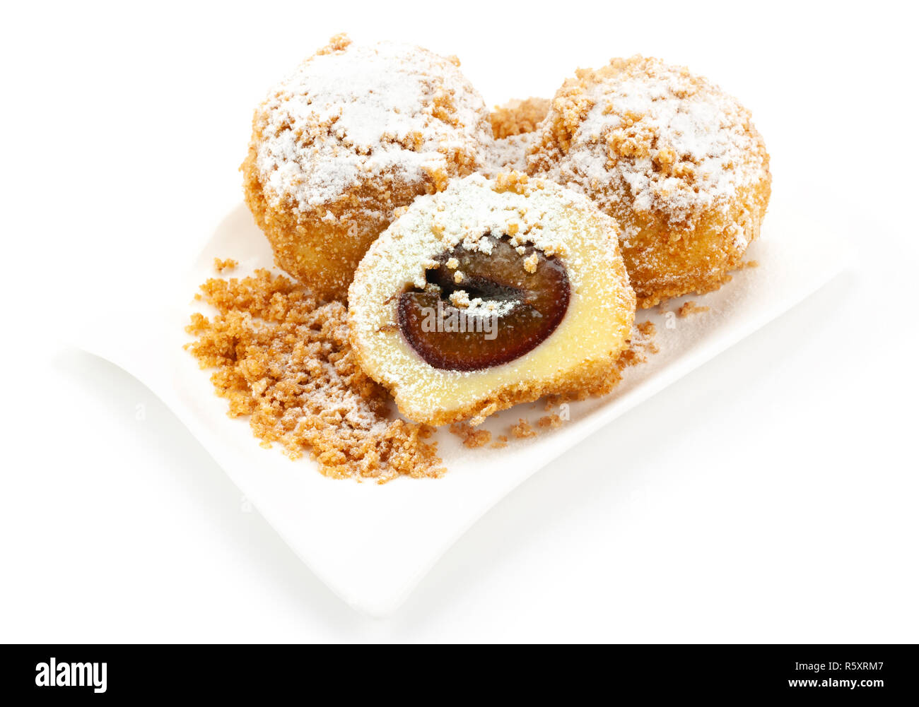 Plum dumplings on white background Stock Photo