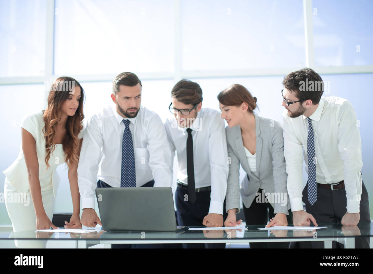 business team standing near the desktop Stock Photo - Alamy