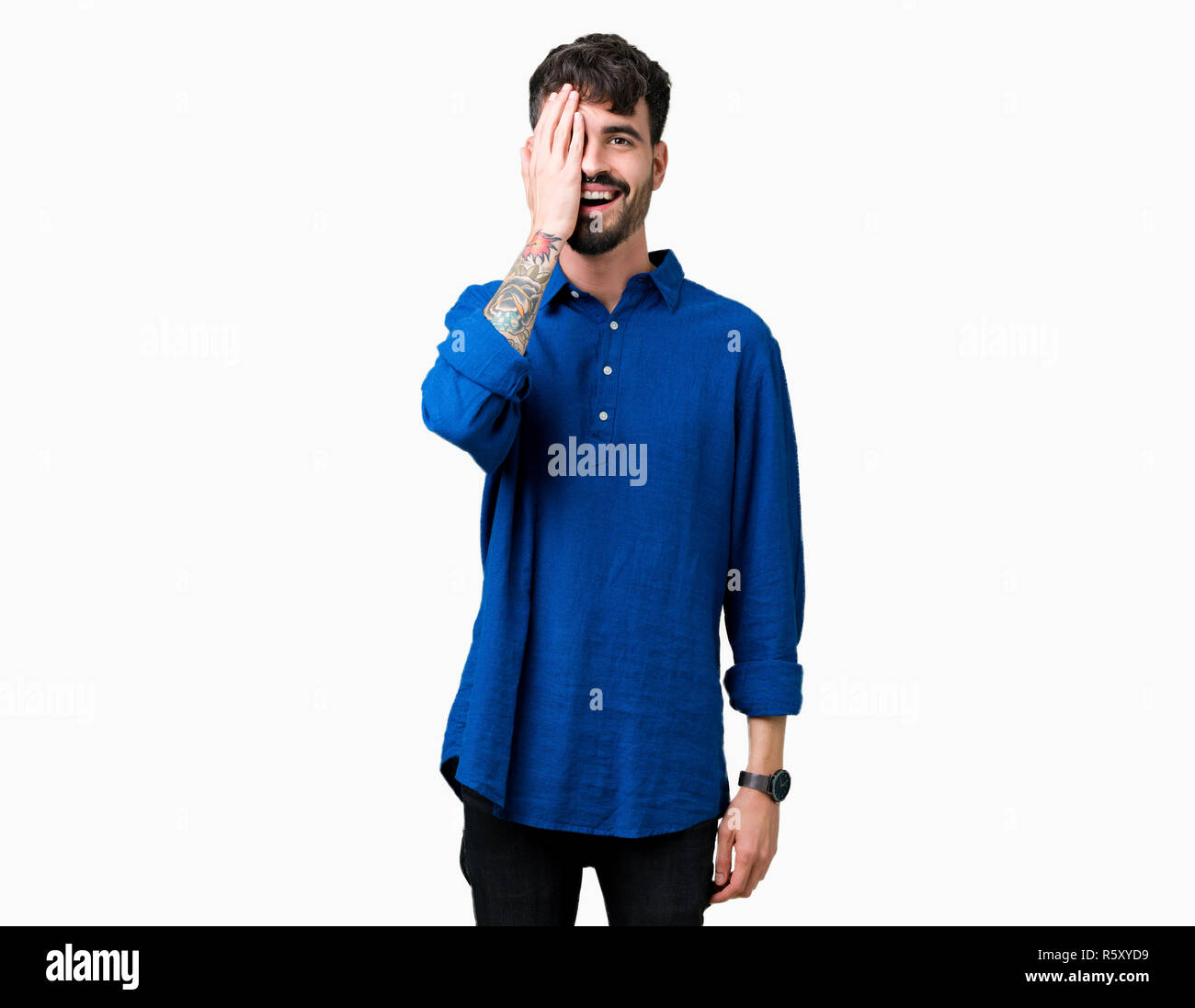 Young handsome man over isolated background covering one eye with hand ...