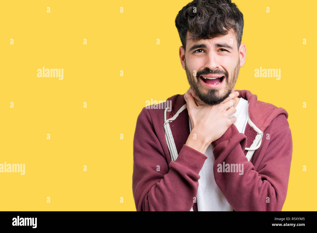 Young handsome man over isolated background shouting and suffocate