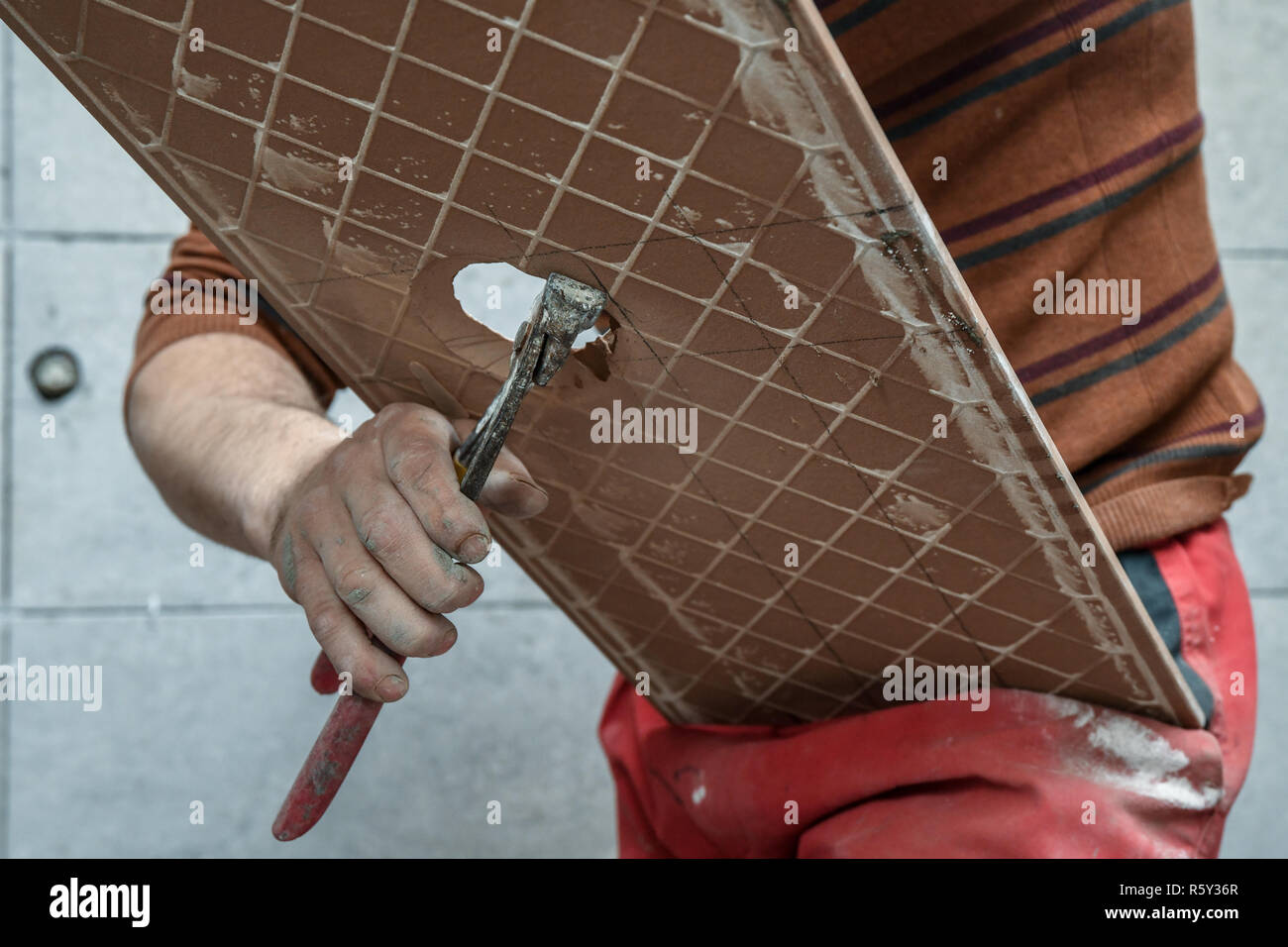 Cutting ceramic tiles. Opening a hole in the tile Stock Photo Alamy