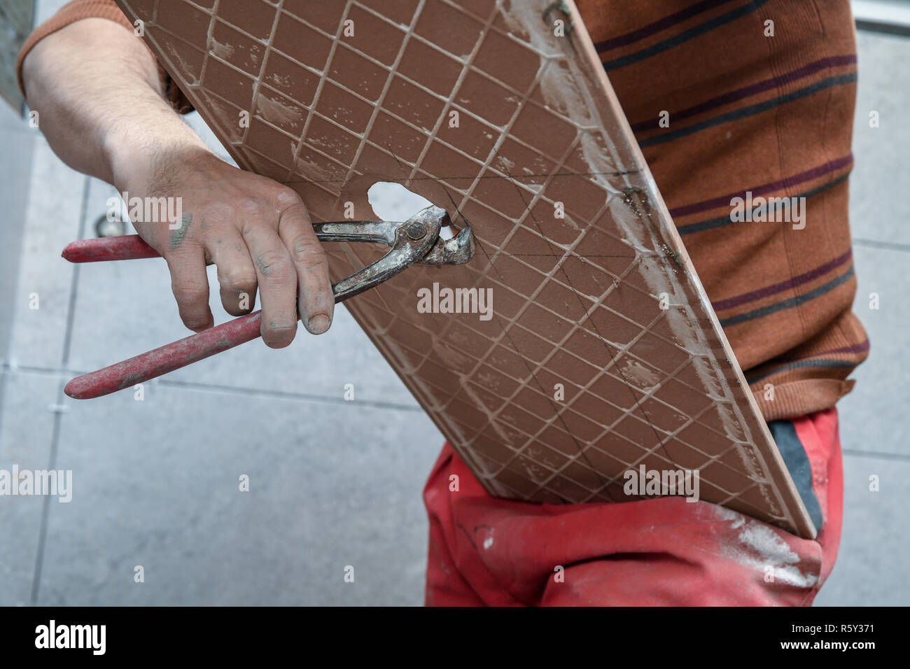 Cutting ceramic tiles. Opening a hole in the tile Stock Photo Alamy
