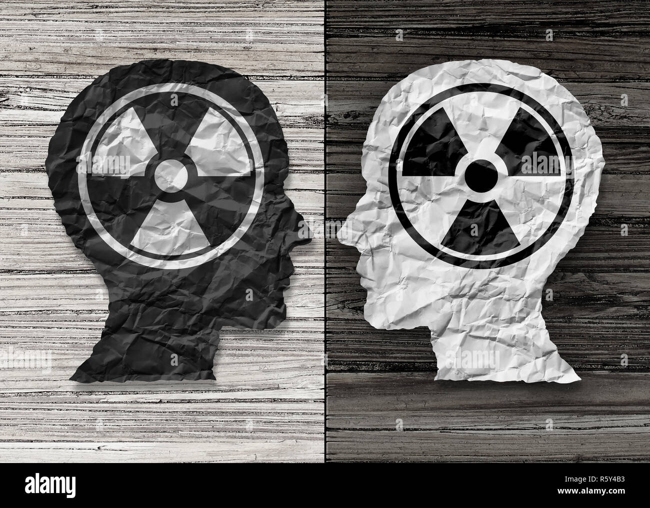 Toxic people psychology concept as a human head in paper divided in two colors as a psychological metaphor for bad social behavior challenges. Stock Photo